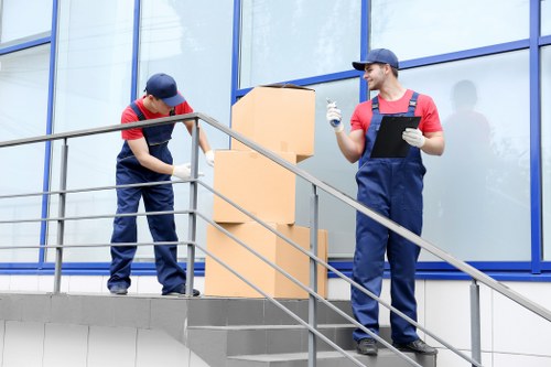 Movers carrying furniture from a residential property in Elephant and Castle